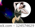 Attractive woman with a bun hairstyle posing with her hands on her head 124574629