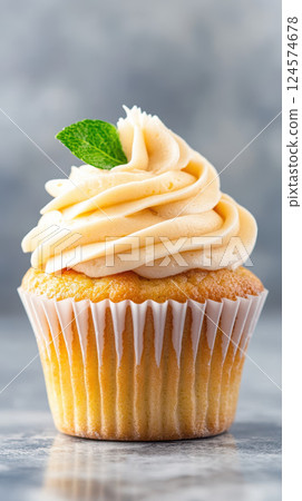 single cupcake with swirled frosting and mint leaf on top single cupcake with swirled frosting and mint leaf on top 124574678