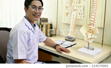 A therapist sitting at a desk and looking back 124574991