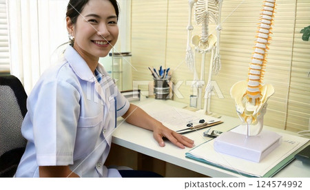 A therapist sitting at a desk and looking back 124574992