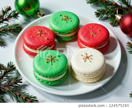 Festive holiday macarons on white plate with pine branches - christmas dessert theme 124575293