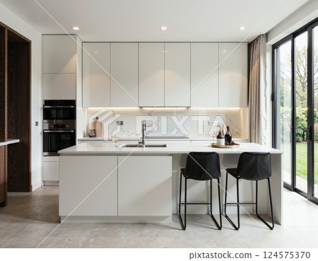 Modern minimalist kitchen design with sleek white cabinets and natural light for contemporary homes 124575370