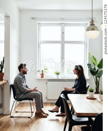 Modern office meeting space with natural light and greenery ideal for creative collaboration and productive discussions 124575376