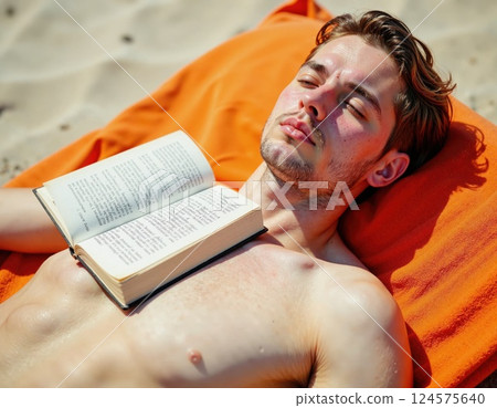 Sunlit relaxation: young man sunbathing with book on vibrant beach towel for summer leisure inspiration 124575640