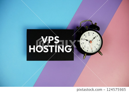 VPS Hosting text with alarm clock on paper card on blue, purple, pink geometric background 124575985