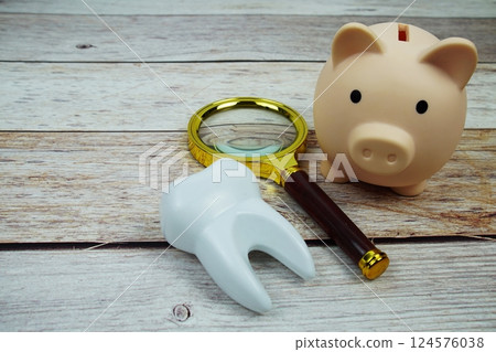 Toothbrush dental hygiene concept with magnifying glass on wooden background Toothbrush dental hygiene concept with magnifying glass on wooden background 124576038