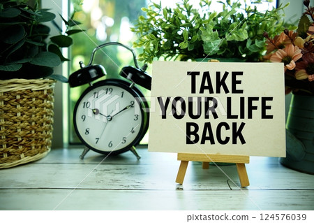Take Your Life Back text motivational and inspiration quote with alarm clock on wooden background Take Your Life Back text motivational and inspiration quote with alarm clock on wooden background 124576039