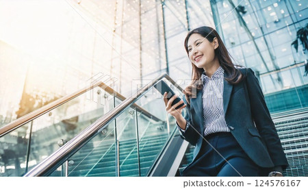 Businesswoman walking up the stairs of an office building 124576167