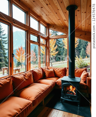 Cozy autumn retreat with mountain view and warm rustic interior design 124576478