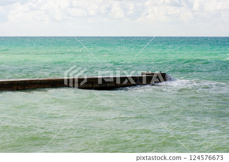 Breakwater structure coastal area to protect against tides, currents, waves, and storm surges Breakwater structure coastal area to protect against tides, currents, waves, and storm surges 124576673