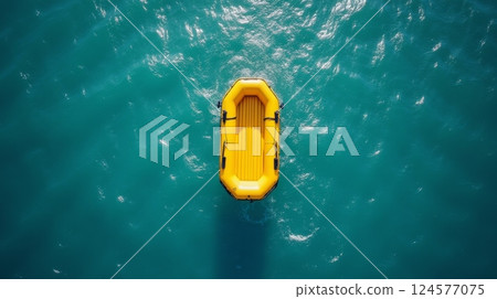 Yellow inflatable lifeboat floating on turquoise water, top view. Marine rescue, emergency survival, and adventure concept with copy space 124577075
