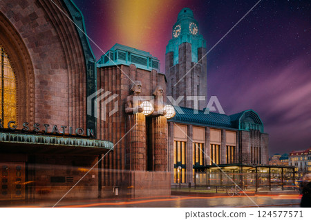 Helsinki, Finland. Night View Of Statues On Entrance To Helsinki Central Railway Station. Evening Or Night Illumination. Night stars shining above street Helsinki, Finland. Night View Of Statues On Entrance To Helsinki Central Railway Station. Evening Or Night Illumination. Night stars shining above street 124577571
