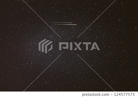 Real Night Sky Stars With Milky Way Galaxy. Natural Starry Sky Background with meteor trails lights. Background Night Starry Sky With Bright Stars And Meteoric Track Trail Real Night Sky Stars With Milky Way Galaxy. Natural Starry Sky Background with meteor trails lights. Background Night Starry Sky With Bright Stars And Meteoric Track Trail 124577573