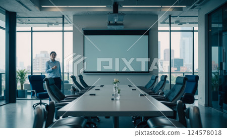 Business meeting room preparation with modern white table, black chairs, large windows, urban skyline, team setup, projector screen, contemporary office space 124578018