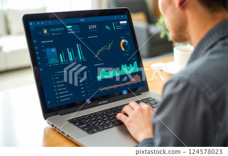 Businessman using laptop analyzing financial dashboard with graphs and charts in modern office, data review, finance, investment, productivity, technology, workspace, economic analysis 124578023