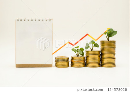 blank notebook financial success concept with growing coin stacks young plants rising graph. investment savings economy profit business strategy wealth management blank notebook financial success concept with growing coin stacks young plants rising graph. investment savings economy profit business strategy wealth management 124578026