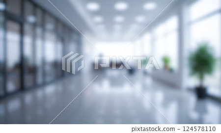 Blurred office environment with natural light, spacious interior, modern furniture, glass walls, indoor plants, and professional work atmosphere for business visual 124578110