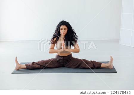 Brunette Yoga Woman Doing Asana Gymnastics On Floor 124578485