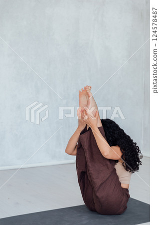 Yogi woman brunette doing asana gymnastics 124578487