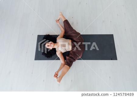Yogi woman brunette doing asana gymnastics 124578489