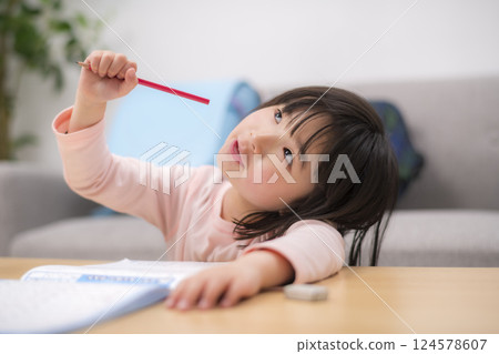 A girl studying at home in the living room 124578607