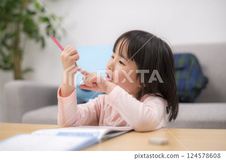 A girl studying at home in the living room 124578608