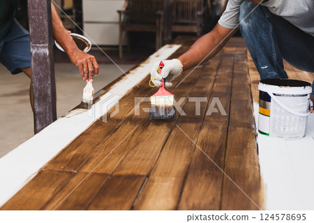 Two house painter painting a floor outside the house. Two house painter painting a floor outside the house. 124578695