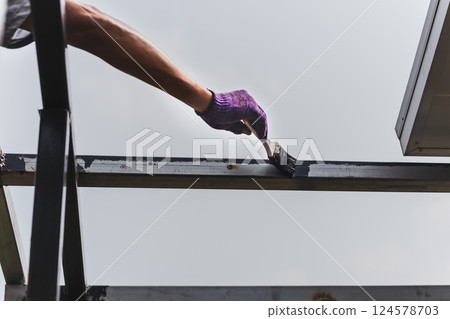 Hand painting anti rust paint on steel at home decorated. 124578703