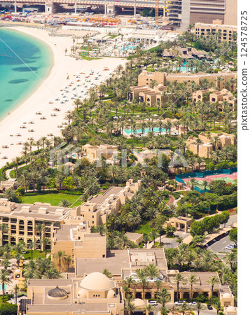 Beach coast with open pool hotels in Dubai. View from the height. Beach coast with open pool hotels in Dubai. View from the height. 124578725