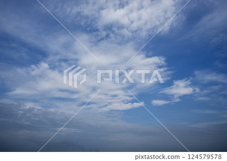 Tropical summer blue sky fluffy white cloud summertime on light sunny day cloudscape. Clear bright blue skyline spring sunlight climate background. Heaven blue environment ecology high scenic nature. 124579578