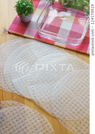 Rice paper and a bowl of water | Image of soaking rice paper in water 124579919