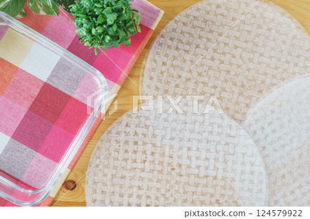 Rice paper and a bowl of water | Image of soaking rice paper in water 124579922