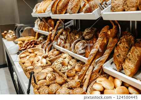 Large bakery counter. Small business, selling freshly baked bread. Hot buns and pies. 124580445