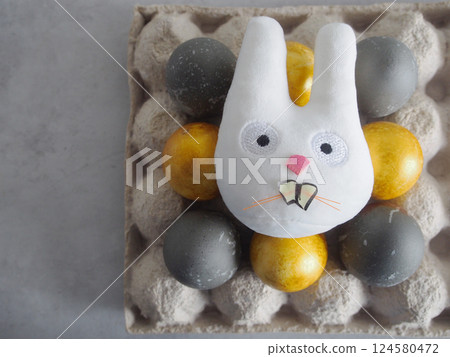 Bright Eggs and rabbit laid out on a tray Bright Eggs and rabbit laid out on a tray 124580472