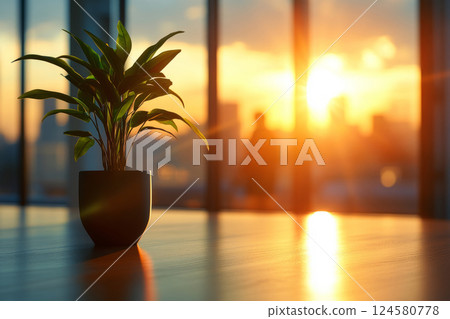 Office plant in sunlight with blurred figures in background 124580778