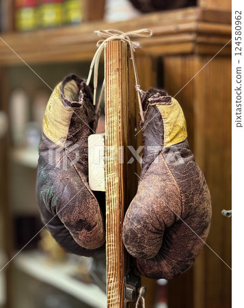 The Fighter's Rest: Worn Boxing Gloves 124580962