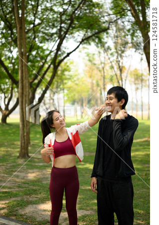 cheerful young couple resting after a workout in a sunny, green park cheerful young couple resting after a workout in a sunny, green park 124581718