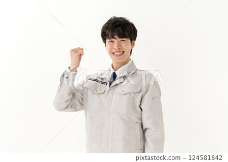 Young man in work clothes, fist pump Young man in work clothes, fist pump 124581842