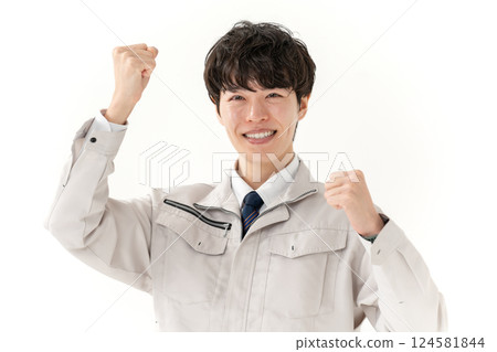 Young man in work clothes, fist pump 124581844