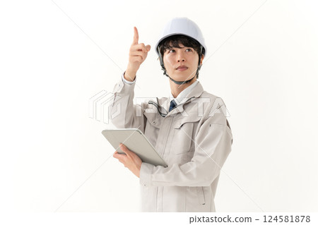 Young man in work clothes, tablet Young man in work clothes, tablet 124581878