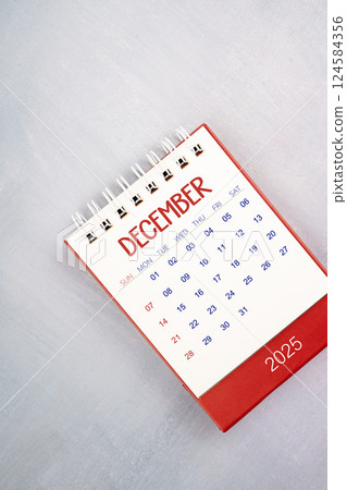 December 2025 on gray wooden table, Flat lay. 124584356