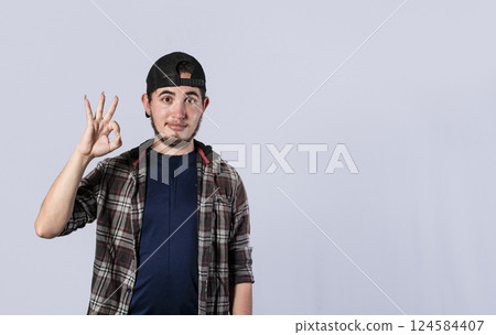 Young man making ok gesture, expression of everything is fine, Concept of no problem Young man making ok gesture, expression of everything is fine, Concept of no problem 124584407