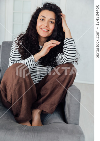 Beautiful slender brunette woman smiling sweetly 124584450