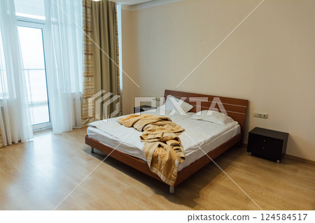 Empty white bed with linen in the bedroom in the morning 124584517
