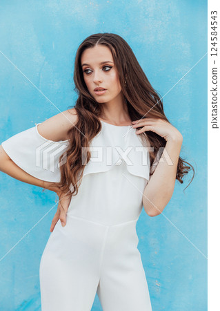 Beautiful Slim Fashion Woman in White Suit on Blue Background 124584543