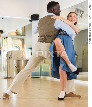 Man and woman performing ballroom dance in dancing room Man and woman performing ballroom dance in dancing room 124585280