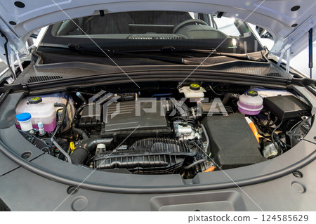 Hybryd car with open hood. Close up of inverter and engine 124585629
