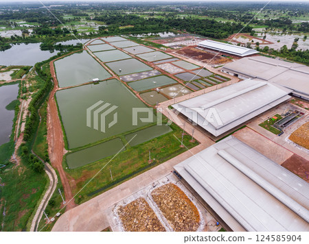 The aerial view of many ponds and paths near the manufactory shot by drone. 124585904