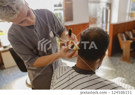 A Highly Skilled Barber Is Expertly Styling Hair Within a Charming Vintage Barbershop Scene A Highly Skilled Barber Is Expertly Styling Hair Within a Charming Vintage Barbershop Scene 124586151