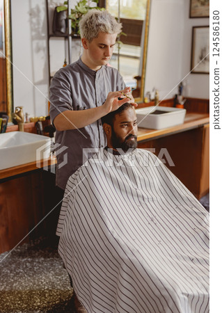 A Modern Barber is Providing Exceptional Grooming Services in a Stylish and Inviting Salon 124586180